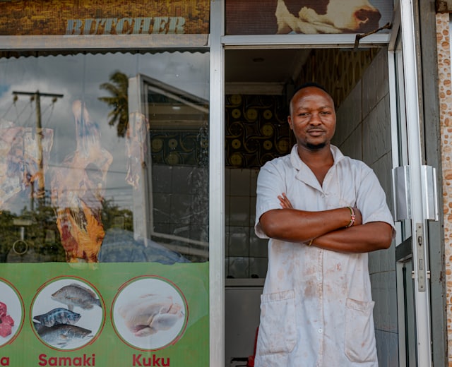 Owner standing in front of a food and provisions shop